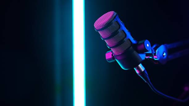 istock Studio microphone with neon lighting and futuristic ambiance 2205724537