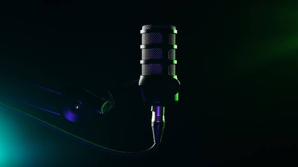 istock Studio microphone with green and purple atmospheric lighting 2205724827