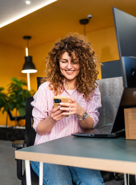 istock Woman using phone in the office 2205727935