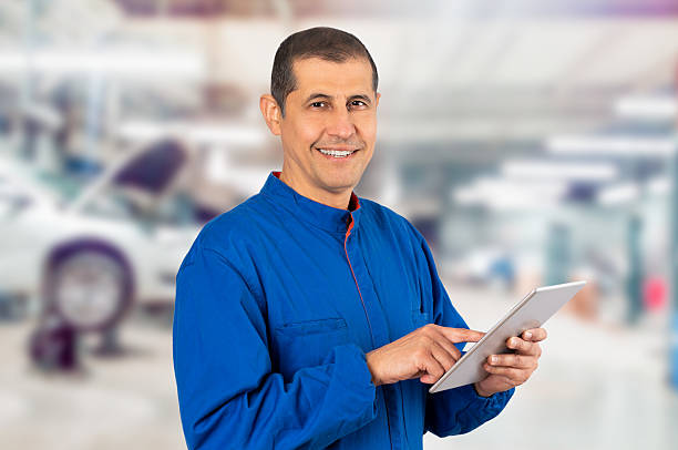 istock Smiling mechanic working with tablet at the workshop 2205730153
