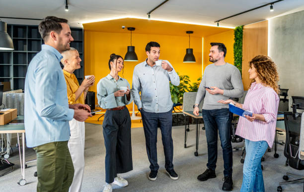 istock Colleagues having a coffee break in a workplace 2205730731