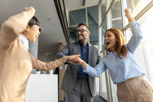 istock Excited business team celebrating success in modern office 2205732938