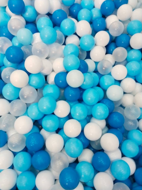 istock White and bright blue balls with a shiny and colorful pattern creates a textured background 2205737098