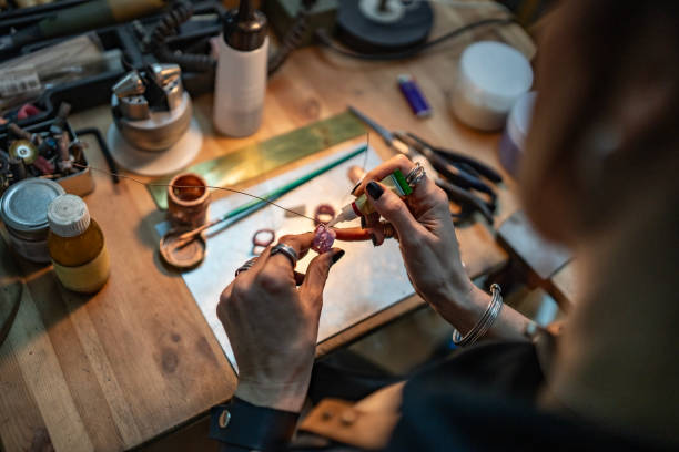 istock Craftsman Handcrafting Jewelry with Precision in a Workshop Setting 2205737616