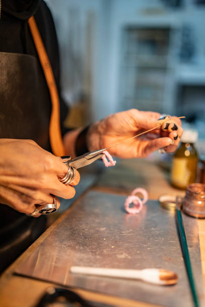 istock Hands Crafting Jewelry with Tools in a Workshop Environment 2205737642