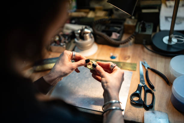istock Artisan Crafting Jewelry in a Workshop Under Desk Lamp Illumination 2205737766
