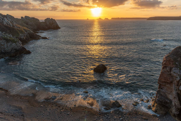 istock Pointe de Dinan. The ocean is calm and the sun is setting, creating a beautiful 2205747200