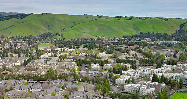 istock Apartment Complexes in Fremont, CA with Grassy Hills Beyond 2205747959