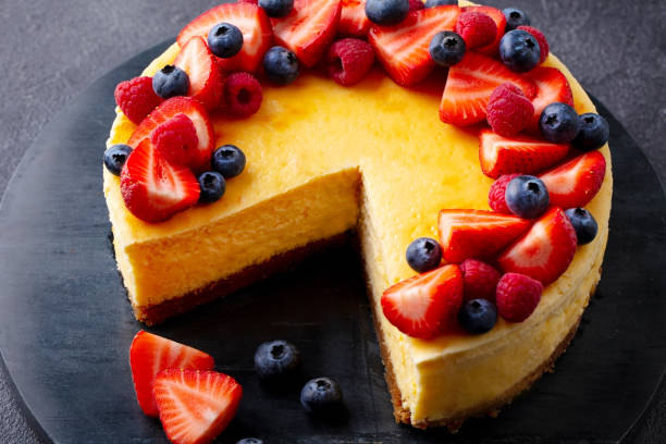 istock Cheesecake dessert with fresh berries. Dark background. Close up. 2205751288