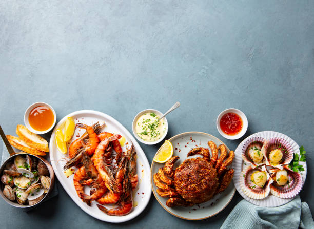 istock Seafood buffet. Prawns, crab, oysters, langoustines, scallops on grey background. Copy space. Top view. 2205751320