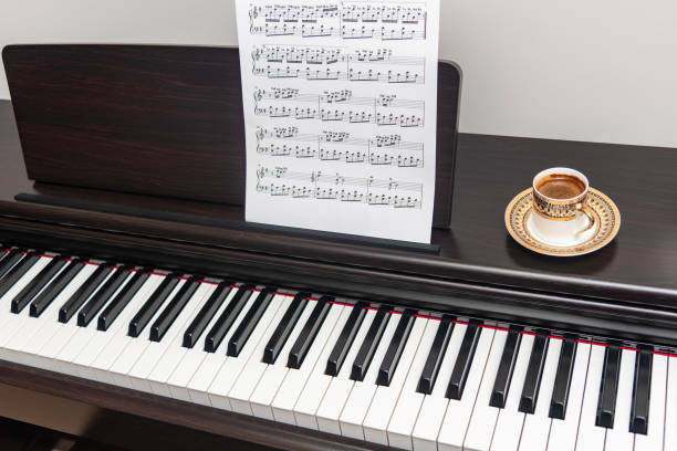 istock Piano and piano keyboard and A cup of coffee with musical note 2205753190
