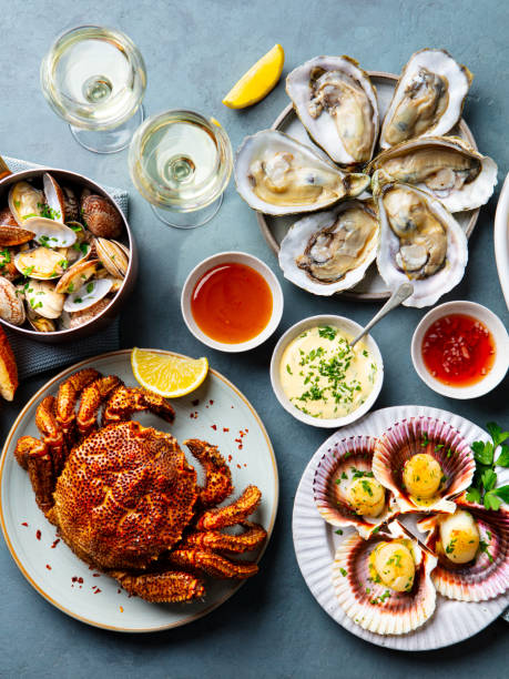 istock Seafood buffet, crab, oysters, scallops with white wine on blue background. Top view. 2205755071