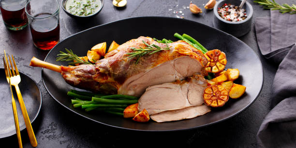 istock Roasted lamb leg with green bean and red wine. Grey background. Close up. 2205755084