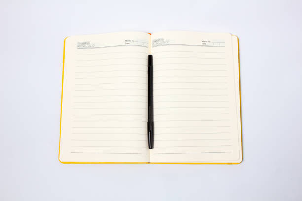 istock notebook and black pen isolated on white background.education concept 2205755373