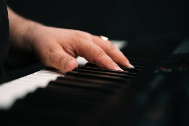istock Piano player hands playing keyboard musical instrument music production studio 2205755749