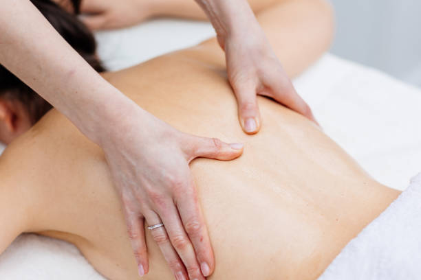 istock Young woman enjoying therapeutic massage in spa 2205757790