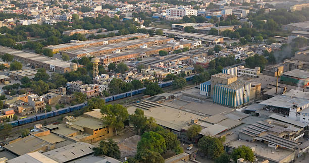 Aerial shot of a freight train in Basni Phase 2, an industrial area in Jodhpur, Rajasthan, India on a smoggy day.