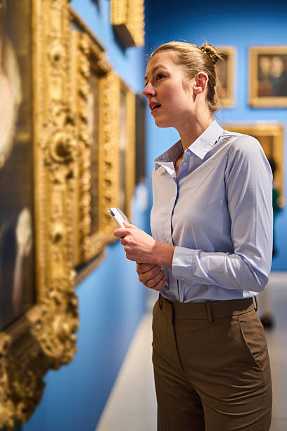 istock visitor in historical museum looking at art object 2205761216