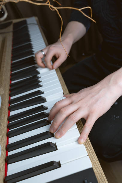 istock A musician playing a beautiful piano while wearing a ring on their finger 2205761570