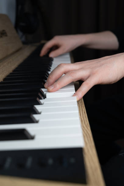 istock This image shows a closeup of an individual skillfully playing a piano 2205761587