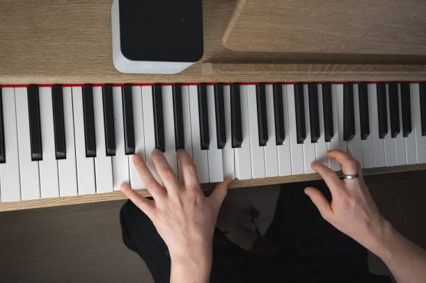 istock An individual skillfully playing a piano while wearing a ring on their finger 2205761633