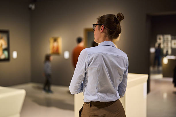 istock visitor in historical museum looking at art object 2205762226