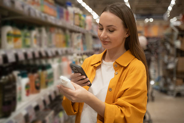 Scanning liquid soap on store shelves while shopping for essentials stock photo