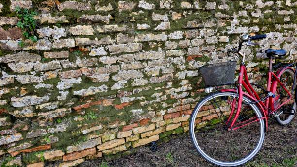 Old bicycle against brick wall