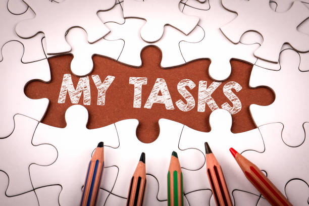 istock MY TASKS. White puzzle pieces and colored pencils 2205766119