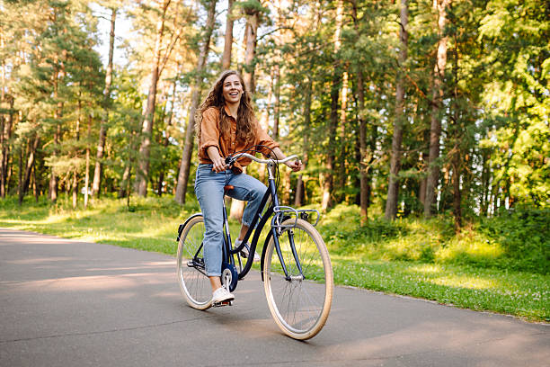 istock Young modern woman rides bicycle in the park. 2205766675