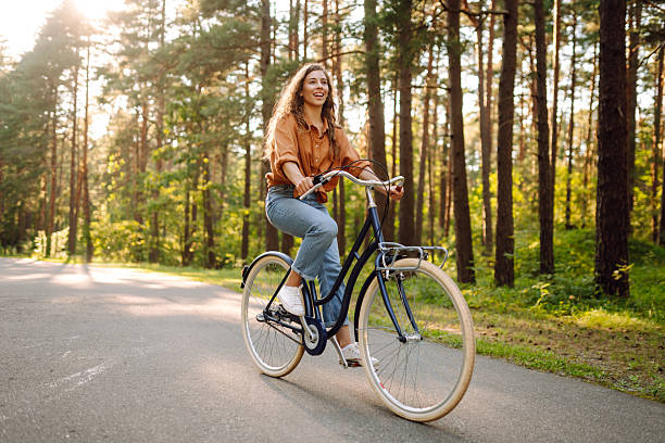 istock Young modern woman rides bicycle in the park. 2205766687