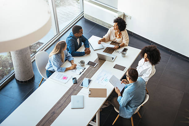 istock Diverse Team Collaborating in Modern Office Around a Conference Table 2205767853