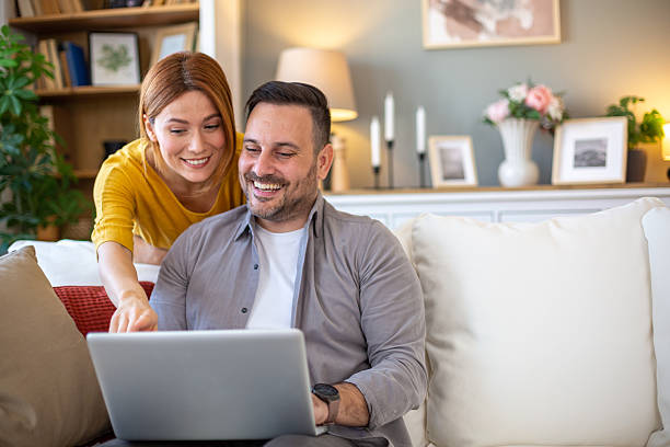 istock Happy couple searching the web together 2205767904
