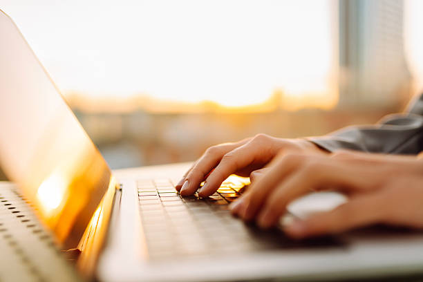 istock Female hands working on laptop  outdoor. 2205768097