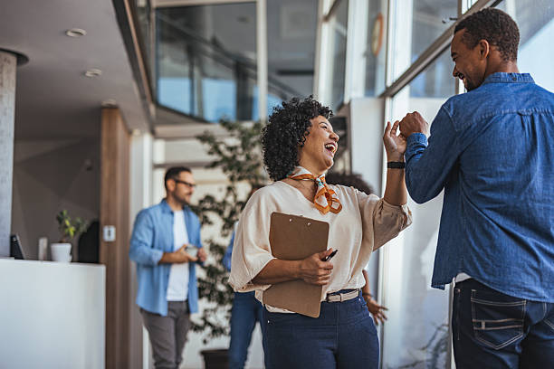 istock Two Colleagues Sharing a Happy Moment in a Modern Office Environment 2205768270