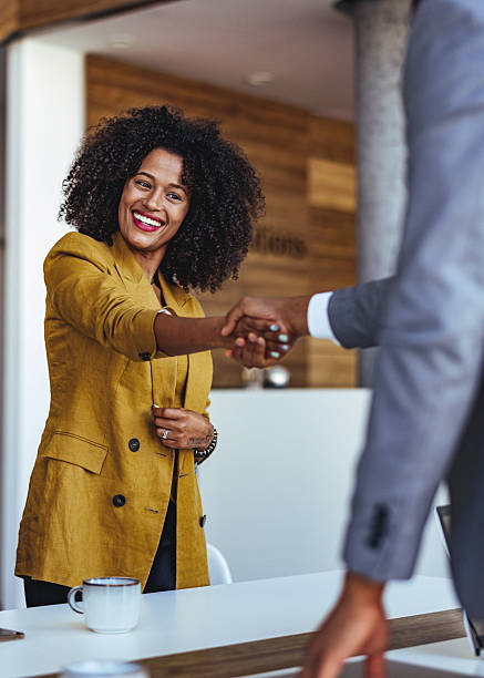 istock Professional Businesswoman Handshaking in a Corporate Office Setting 2205768892