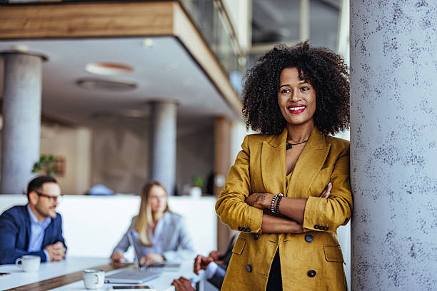 istock Confident Businesswoman Standing in a Modern Office Setting During a Meeting 2205768895