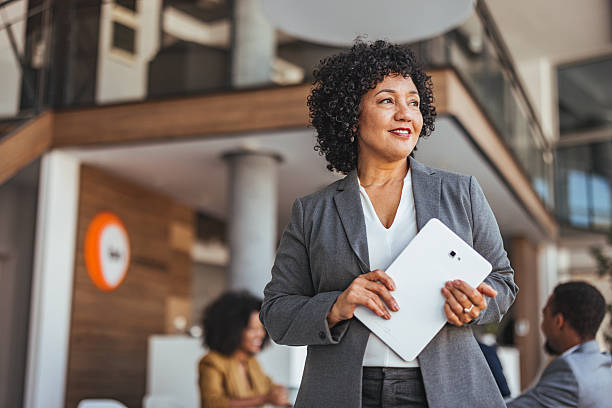 istock Confident Businesswoman Holding a Tablet in a Modern Office Environment 2205769104