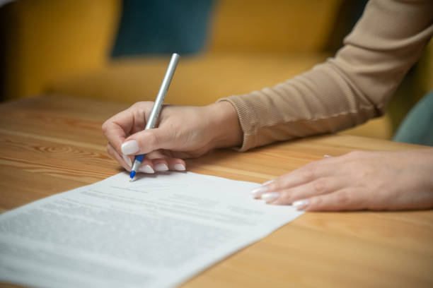 istock Handwriting important documents at a wooden table in a cozy indoor space during the daytime 2205769157