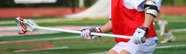 istock Lacrosse Player in Red Jersey Practicing on Field During Daytime 2205769769