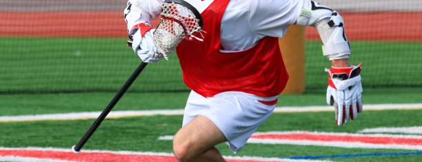 istock Lacrosse Player in Red Jersey Practicing on Field During Daytime 2205769772