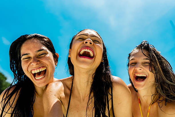 A happy family of mother, father and children, son and daughter, having fun on vacation at a water park