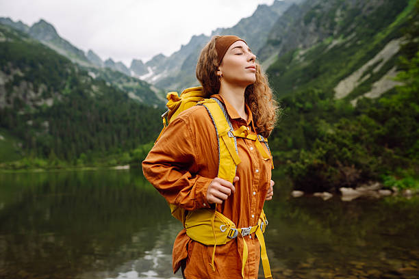 istock Young woman with backpack hiking in the mountains. 2205772661