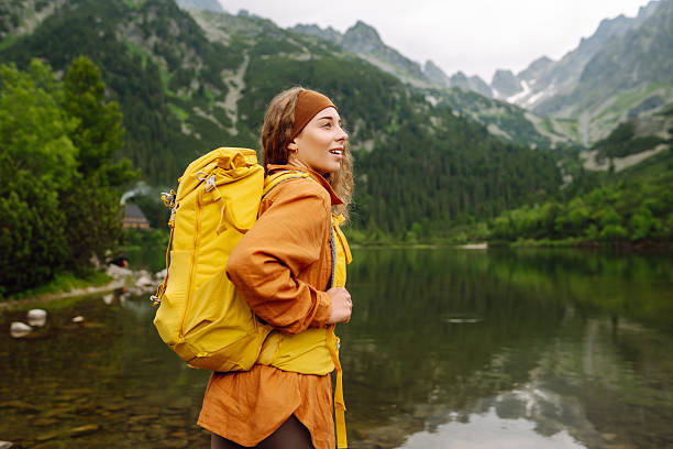 istock Young woman with backpack hiking in the mountains. 2205772663
