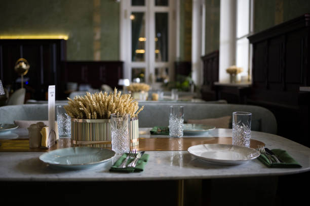 istock modern table setting in a trendy restaurant. Sofa, armchair, table and dishes on the table 2205773044