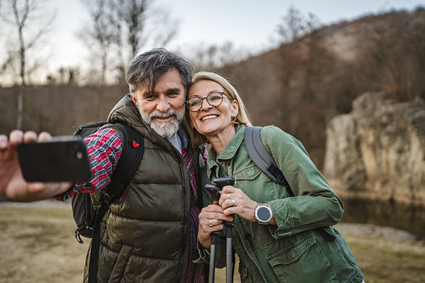 istock happy couple hiker backpacker explore forest and take self portrait 2205775575