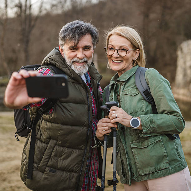 istock happy couple hiker backpacker explore forest and take self portrait 2205775614