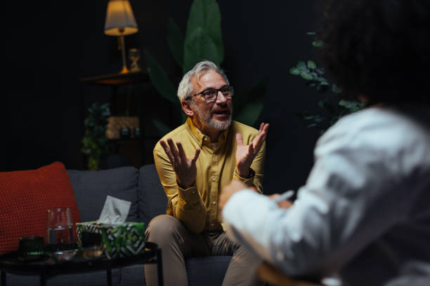 istock Senior man talking to his therapist during therapy session 2205776843