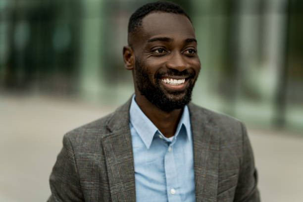 istock Smiling black businessman walking from work outdoors. 2205776926