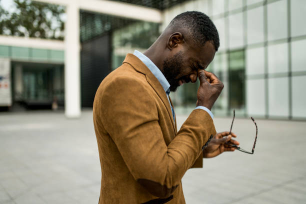 istock Tired black businessman having eyesight problems outdoors. 2205777202